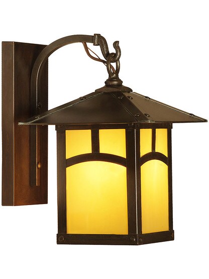 Evergreen Single Sconce with Arch Pattern in Bronze Finish with Tan Glass.